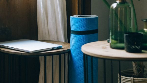 Minimalist, spacious room with a yoga mat on the floor.
