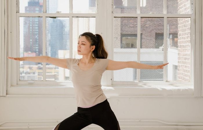 Person in a focused yoga posture, side view.